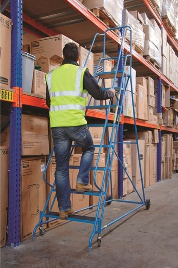 man climbing a rolling ladder