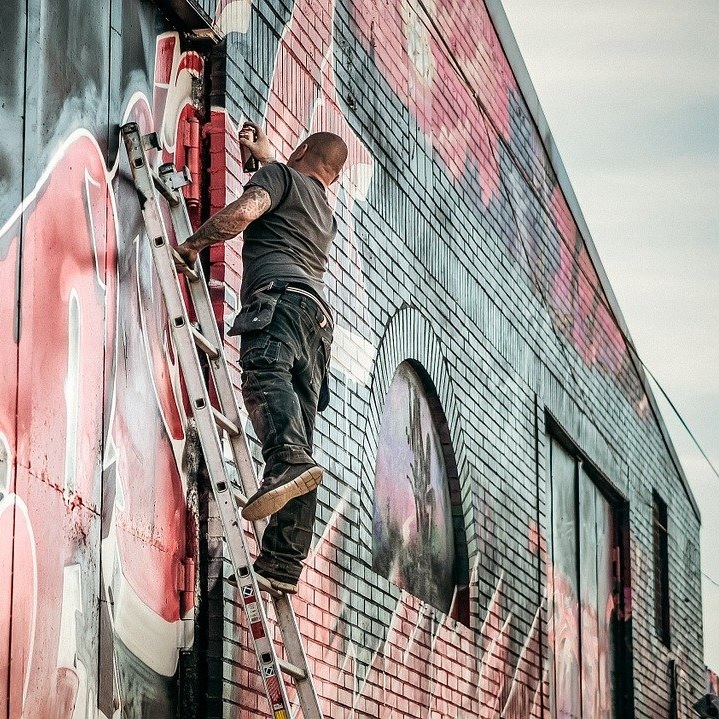 Man using an unsecured ladder