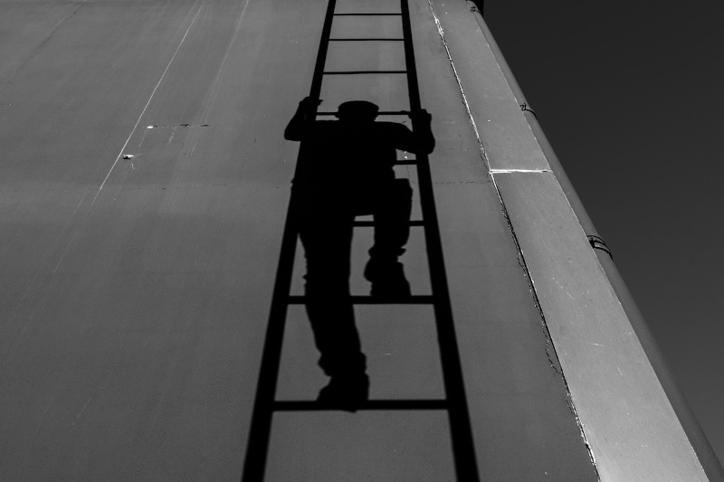 man climbing a ladder