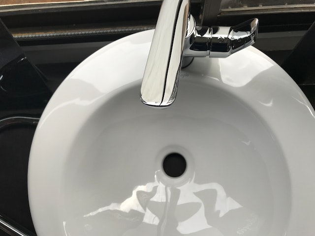 diy tips all homeowners should know - unblocking a sink, image of white porcelain sink with chrome tap.