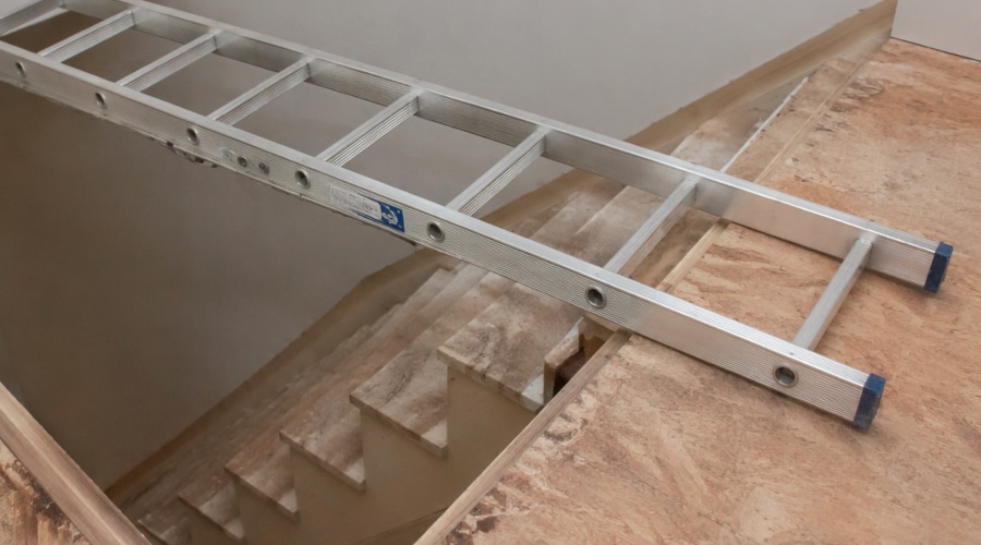 Ladder placed across stairwell opening